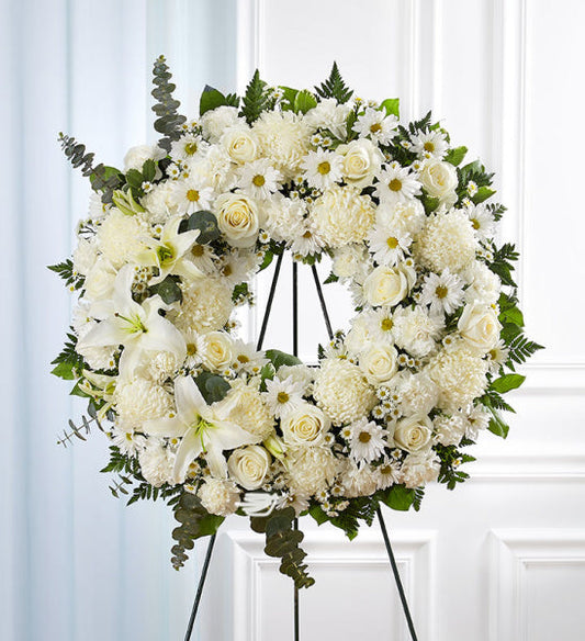 Serene Blessings Wreath in White, funeral standing wreath with white roses, lilies, chrysanthemums, daisies, and mixed greenery