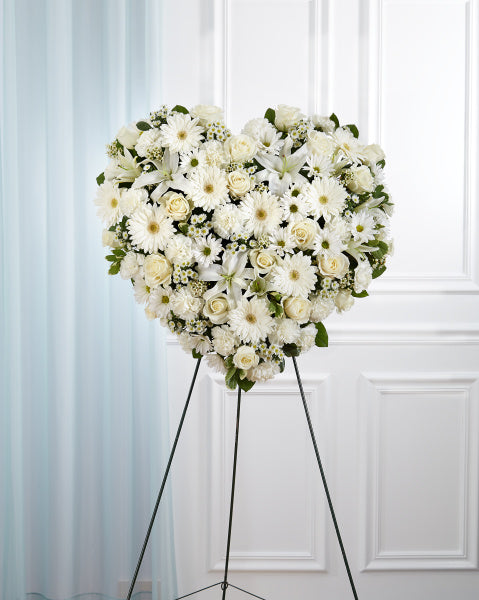 All White Heart Wreath, funeral arrangement with white roses, gerbera daisies, and mixed white flowers
