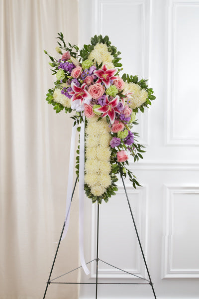 Peace and Prayers Standing Cross in Pastel, funeral flower cross with pink roses, stargazer lilies, statice, and chrysanthemums