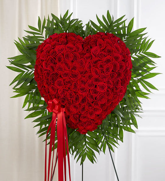Bleeding Heart Rose Wreath, a funeral standing wreath with red roses and palm leaf greenery
