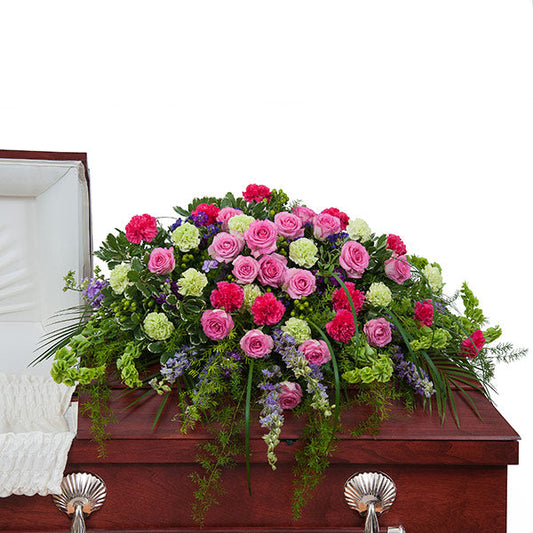 Forever Cherished Casket Spray, half casket spray with pink roses, hot pink carnations, green carnations, purple flowers, and mixed greenery