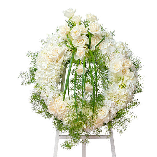 Elegant Wreath, funeral standing wreath with white roses, hydrangeas, and mixed white flowers accented with feathery greenery
